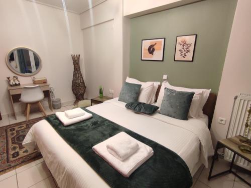 a bedroom with a large bed with towels on it at George's Family house in Larisa