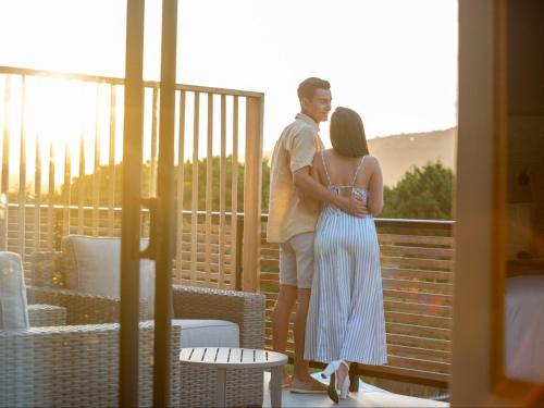 a man and a woman standing on a balcony at IL Gattopardo in Wilderness