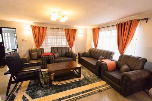 a living room with two couches and a coffee table at Bethel house in Ruiru