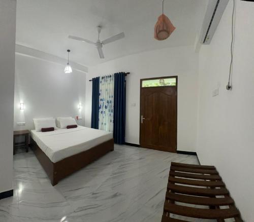 a bedroom with a bed and a chair and a door at The Secret Garden Sigiriya in Sigiriya
