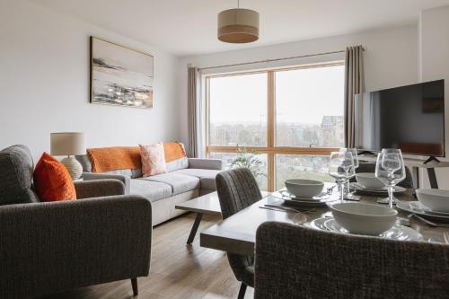 a living room with a couch and a table at Stylish 2BR Apartments by Luxus Sleeps 6 Central Location in Belfast