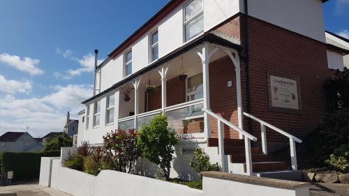 a building with a staircase in front of it at Charnwood Guest House in Lyme Regis