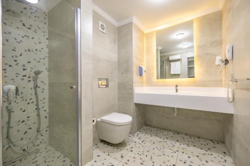 a bathroom with a toilet and a sink and a shower at SOLANA By YELKEN in Turgutreis