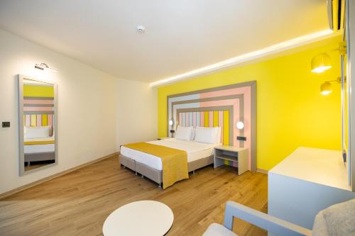 a hotel room with a bed and a couch at SOLANA By YELKEN in Turgutreis