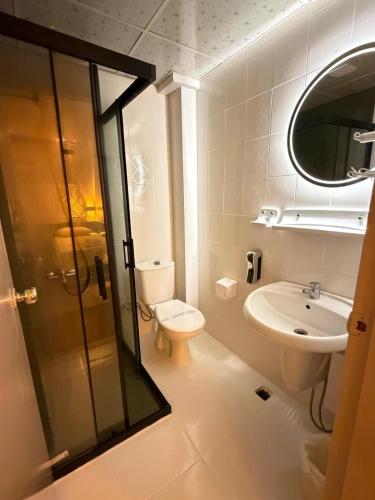 a bathroom with a toilet and a sink and a shower at Hotel Güleryüz 2 in Antalya