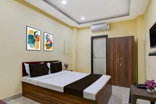 a bedroom with a large bed and a wooden cabinet at Collection O Asian Highway Near Agrasen Hospital Siliguri Formerly Ashiyana Homestay in Binnāguri