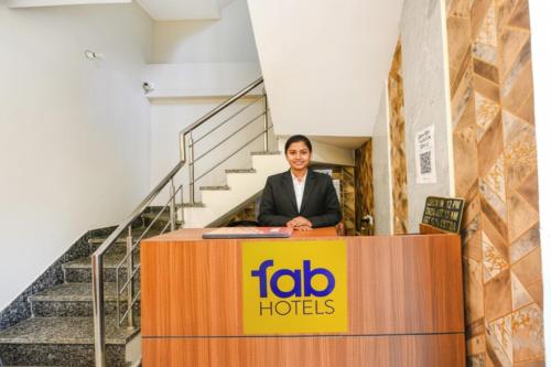 a man standing at a podium behind a table at FabHotel Globe Inn in Ludhiana