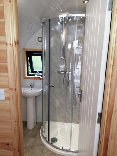 a bathroom with a shower and a sink at Barrhill Holiday Park - Glamping in South West Scotland - Stinchar in Girvan
