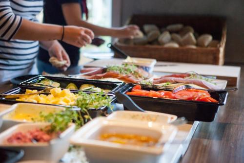 um buffet com muitas bandejas de comida numa mesa em Daftö Resort em Strömstad
