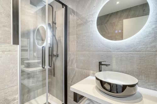 un baño con lavabo y espejo en Anglade Hotel, en Le Lavandou