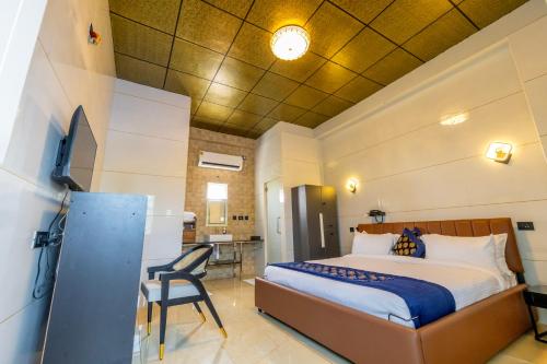 a bedroom with a bed and a chair in a room at W H Nest Hostel in Cochin