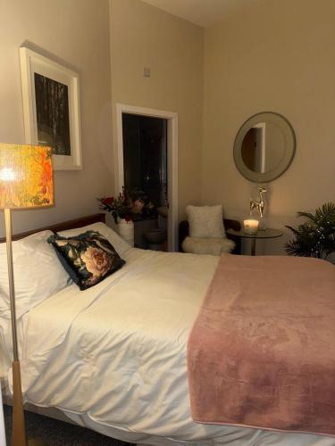 a bedroom with a bed with a pillow on it at NEWLY REFURBISHED NOV 2025 Chic City Stay In Jesmond Apartment in Jesmond
