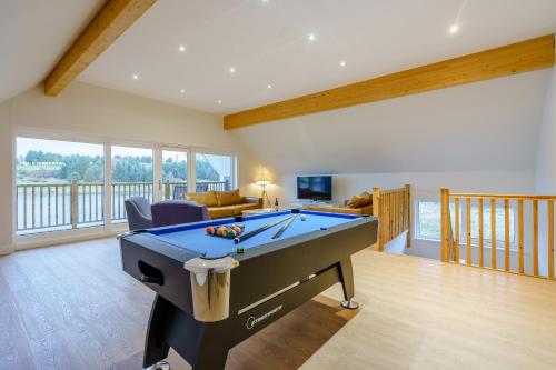 a living room with a pool table in it at Landal Piperdam in Dundee