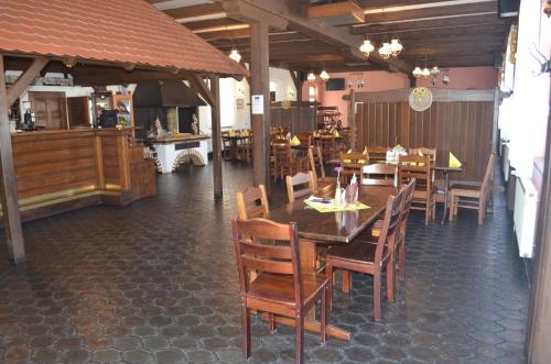 a dining room with tables and chairs in a restaurant at Hotel Na Statku in Nepřevázka