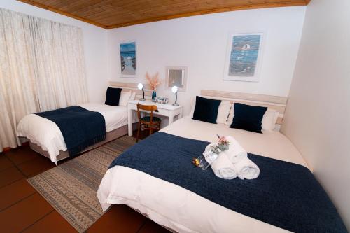 Ένα ή περισσότερα κρεβάτια σε δωμάτιο στο Desert Rose Guesthouse