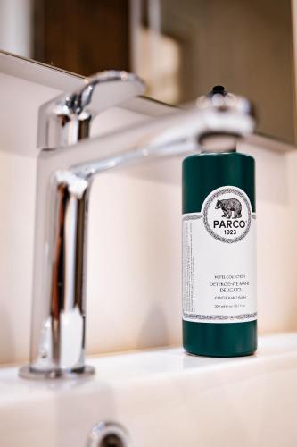 a green bottle of soap sitting on a bathroom sink at BB Maltagliati in Torano Nuovo