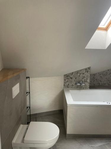 a bathroom with a toilet and a sink and a bath tub at Freigeist Boho in Haßloch