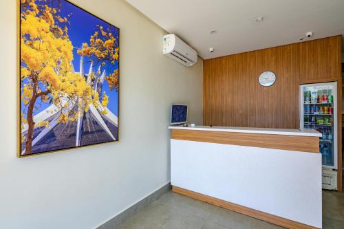 a bar in a store with a painting on the wall at OYO Hotel Brisa Tropical, Brasília in Brasilia