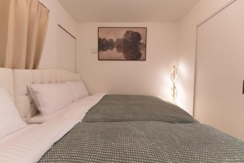 a bedroom with a large white bed in a room at OPEN SALE! 7 min Osu! New! 1LDK! Family! 1 min Park! in Nagoya