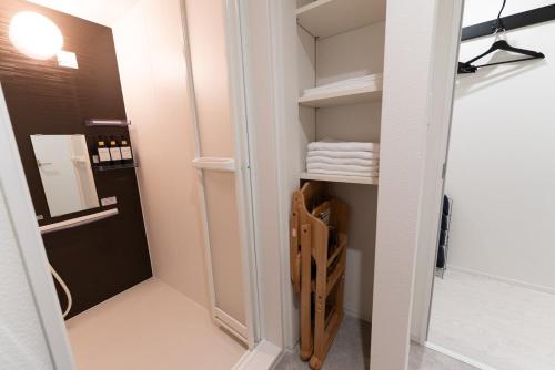 a bathroom with a closet with towels in it at OPEN SALE! 7 min Osu! New! 1LDK! Family! 1 min Park! in Nagoya