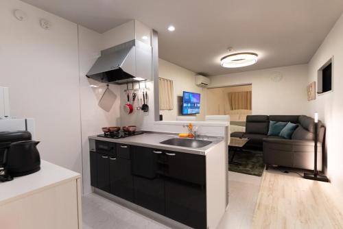 a kitchen with a sink and a counter top at OPEN SALE! 7 min Osu! New! 1LDK! Family! 1 min Park! in Nagoya