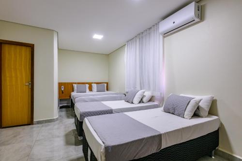 a row of beds in a hospital room at OYO Hotel Brisa Tropical, Brasília in Brasília