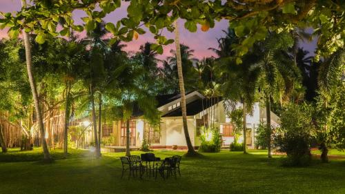a group of chairs in front of a house at Dark Green Resort - Airport Transit Villa in Negombo