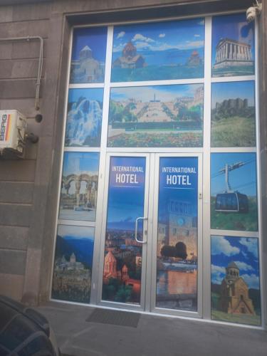 a window of a hotel with pictures of buildings at Hotel International in Yerevan