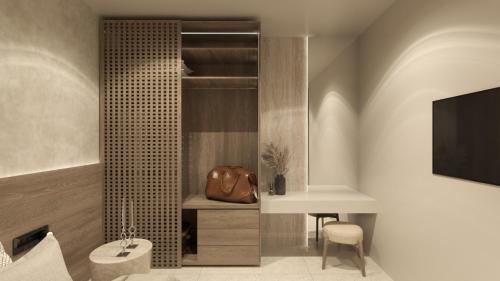 a bathroom with a toilet and a table and a television at Nysa Luxury villa 3 in Anissaras