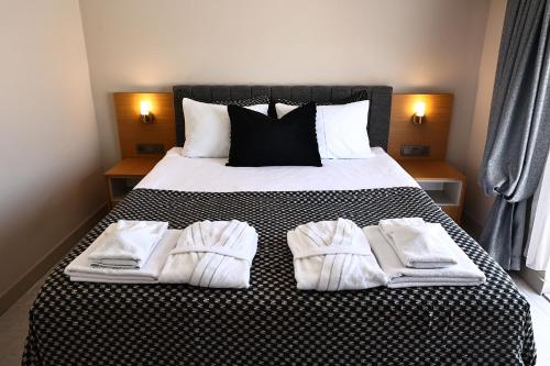 Ένα ή περισσότερα κρεβάτια σε δωμάτιο στο Livia Residence