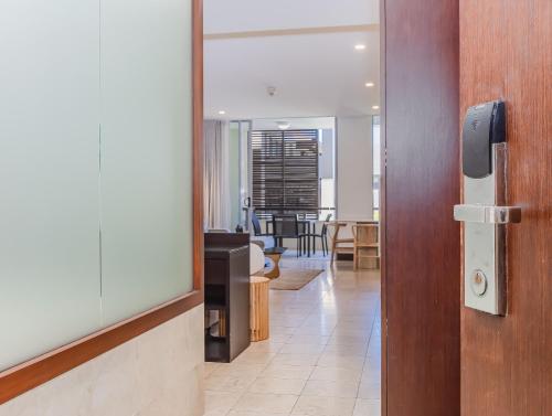 an open door to a room with a dining room at Coastal Bliss Studio - Santai 224 in Casuarina