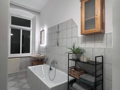 a bathroom with a tub and a sink at Altstadt Studio Sankt Annenblick in Annaberg-Buchholz