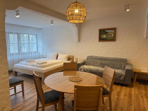 a living room with a table and a couch at Ferienwohnung am Königssee in Schönau am Königssee