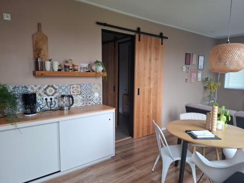 a kitchen and dining room with a table and a dining room at B&B De Terpen in Dokkum