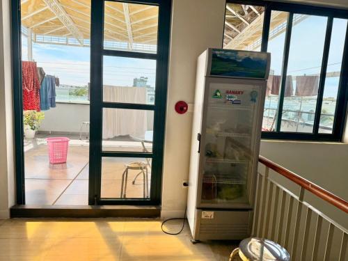 a refrigerator in a room next to a door at Minh Anh Hotel in Phu Quoc