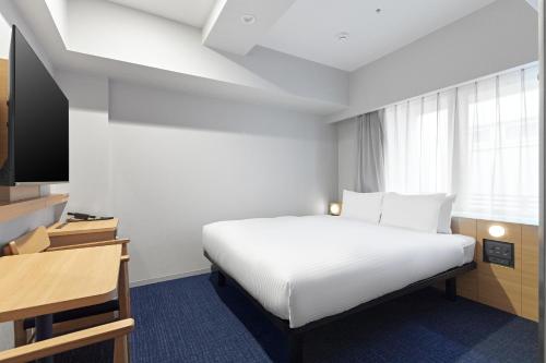 Postel nebo postele na pokoji v ubytování Sotetsu Fresa Inn Kyoto-Kiyomizu Gojo