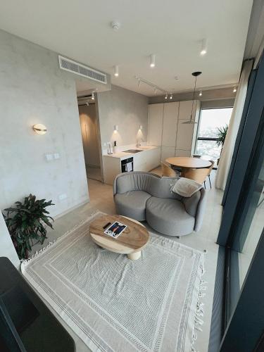 a living room with a couch and a table at Luxury 360 Sea View 27th Floor Apartment in Mercury Tower in St. Julianʼs