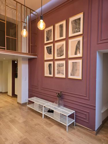 a room with a purple wall with drawings on it at memore in Mons