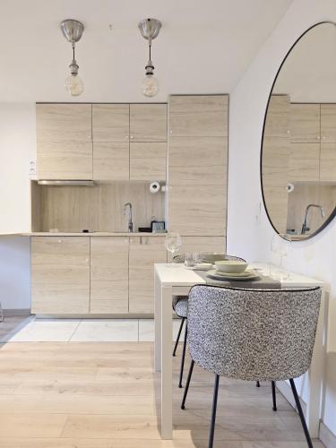a dining room with a table and a mirror at memore in Mons