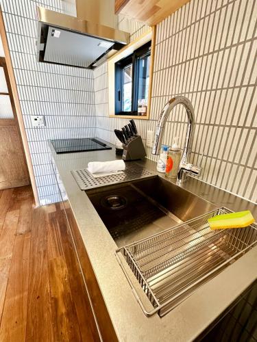 a kitchen counter with a sink and a sink at The Misorano Cottage in Hakuba