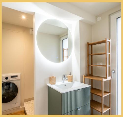 a bathroom with a sink and a mirror at Chez Mathieu I Studio I Sauverny in Sauverny