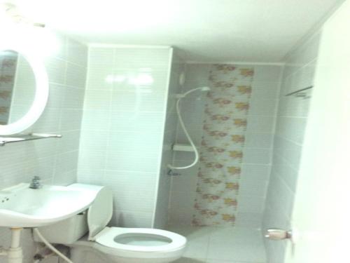 a bathroom with a shower and a toilet and a sink at IMPACT Challenger Muang Thong Thani Service Apartment in Bangkok