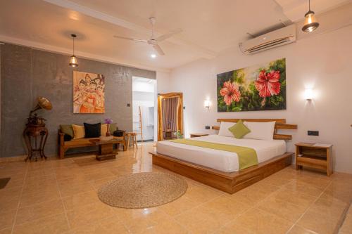 a bedroom with a bed and a living room at Breeze Bay Villa in Dickwella