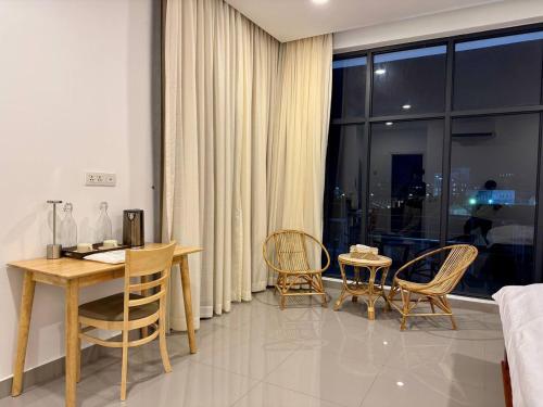 a dining room with a table and chairs and a window at Reatrey Inn in Phnom Penh