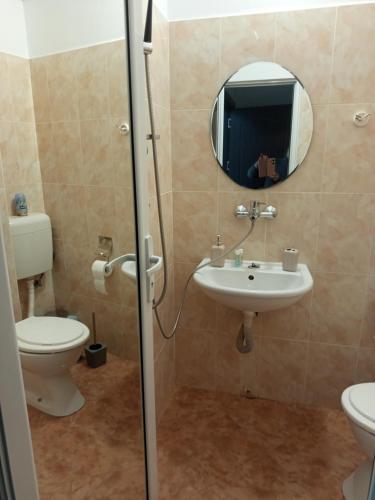 a bathroom with a toilet and a sink at Alena'Studio in Gabrovo