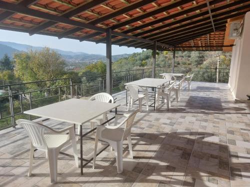 a group of tables and chairs on a patio at Guest House Xhaferaj in Berat