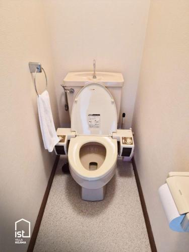 a small bathroom with a toilet in a stall at Large Beachfront Island Villa Sleeps 12 Ideal for Groups in Bizen