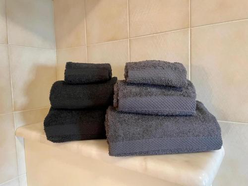 three towels sitting on a shelf in a bathroom at Bormio 5 min - Casa Simona with Wifi and FreePark in Valdisotto