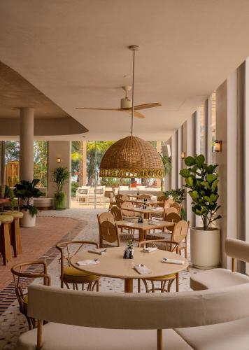 a restaurant with tables and chairs and a gazebo at The Standard, Pattaya Na Jomtien in Na Jomtien