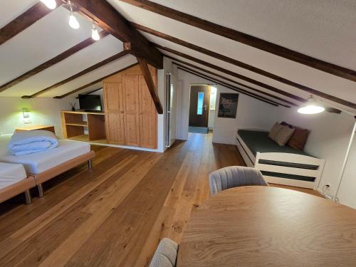 a room with two beds and a table in it at Charming Louisa Zimmer Roof - KEINE KÜCHE in Rueras